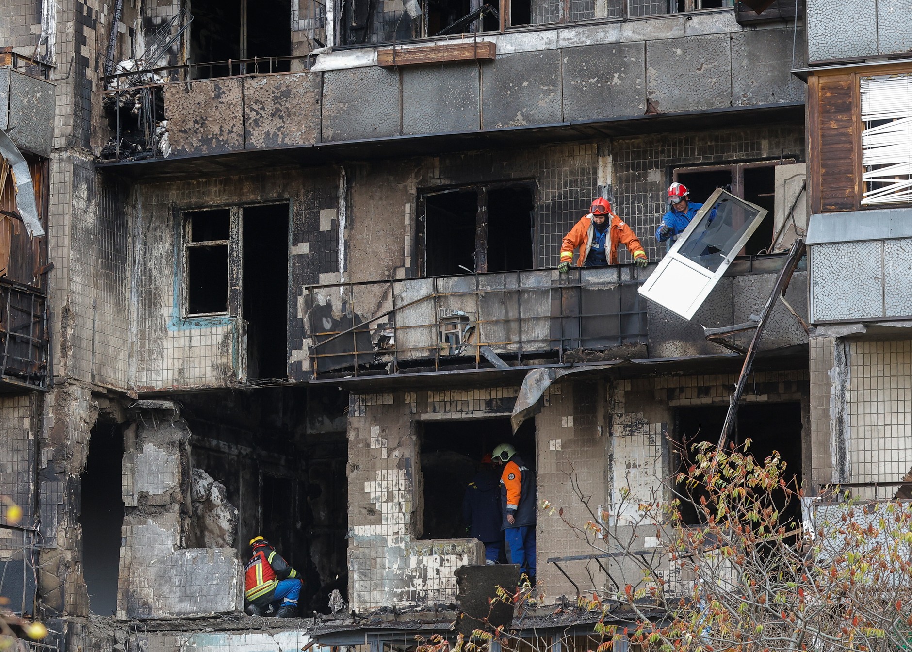 Rescuers work at the site of a Russian attack in Kiev, October 26, 2025.