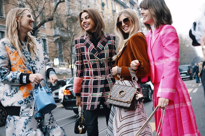 Four fashionably dressed young women on the street