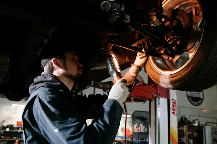 A car mechanic checks the car in service