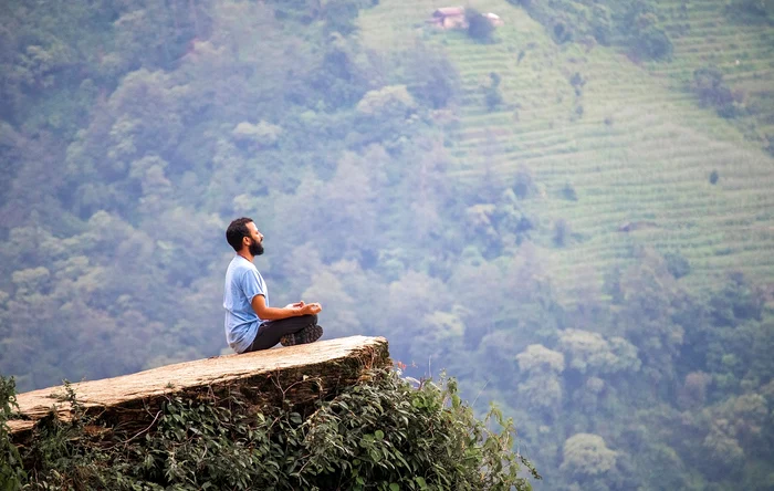 man meditating on the hill