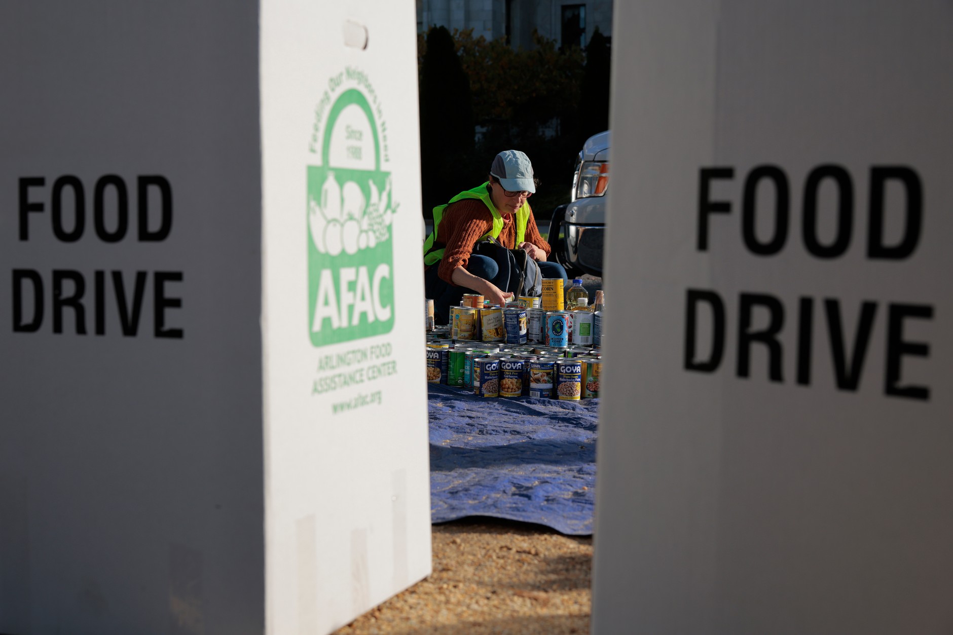 Volunteers sort non-perishable items during a food drive outside the U.S. Department of Agriculture building, Washington, October 30, 2025.
