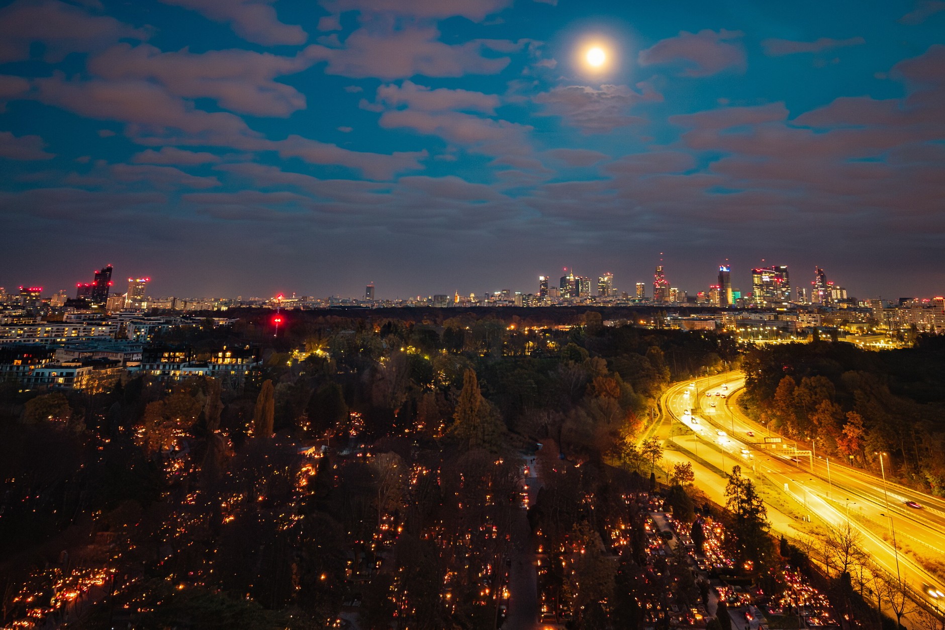 Powązki Cemetery in Warsaw with a view of the city skyline