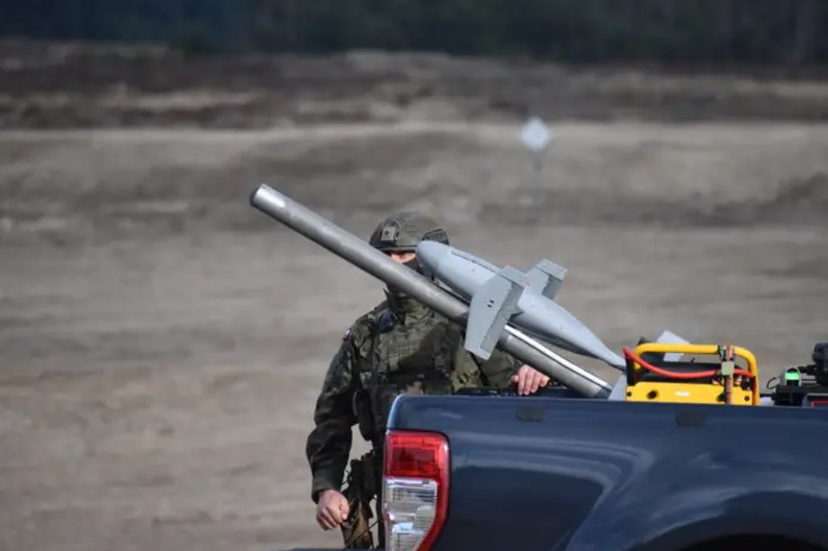 A Polish soldier prepares to launch a Surveryor interceptor drone from the bed of a pickup truck