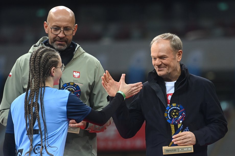 Prime Minister Donald Tusk (R) and Minister of Sport and Tourism Jakub Rutnicki (L-back) during the finale of the campaign "From Orlik to the Stadium" in Warsaw. 