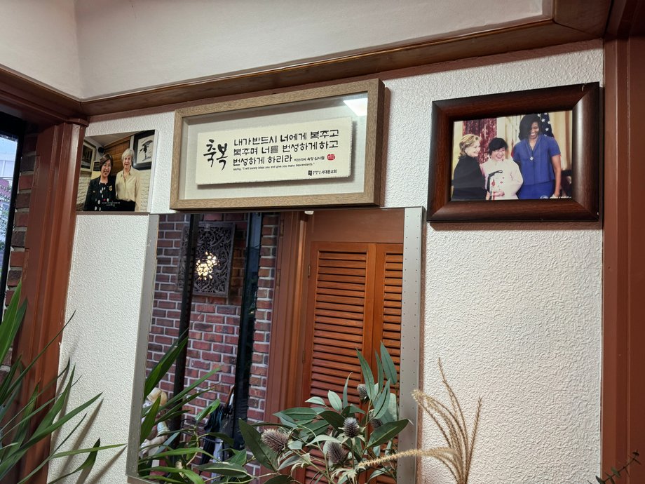 The walls of the restaurant are decorated with numerous photos of the owner and her guests