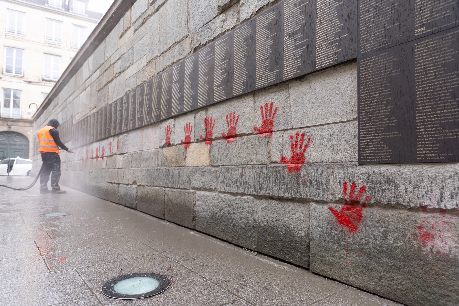 Red hands painted on the Wall of the Righteous in Paris, May 14, 2024.