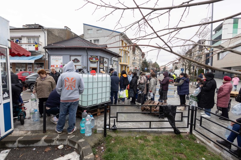 Several people wait in line to fill bottles with drinking water, in the city of Câmpina, Monday, December 1, 2025 | Photo: Inquam Photos / Ovidiu Micsik
