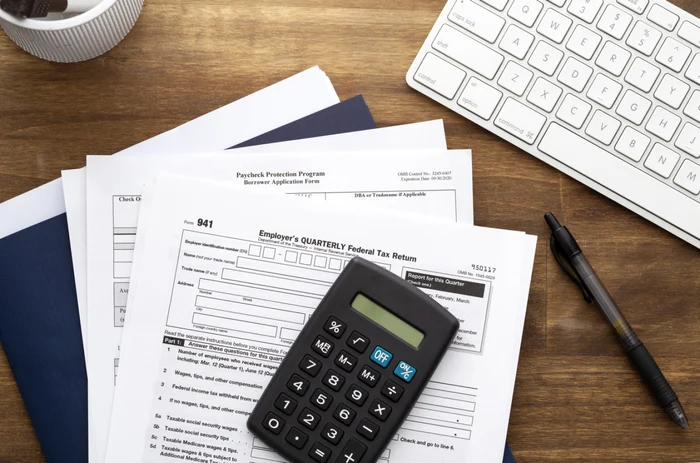 A calculator placed on several forms that must be sent to ANAF