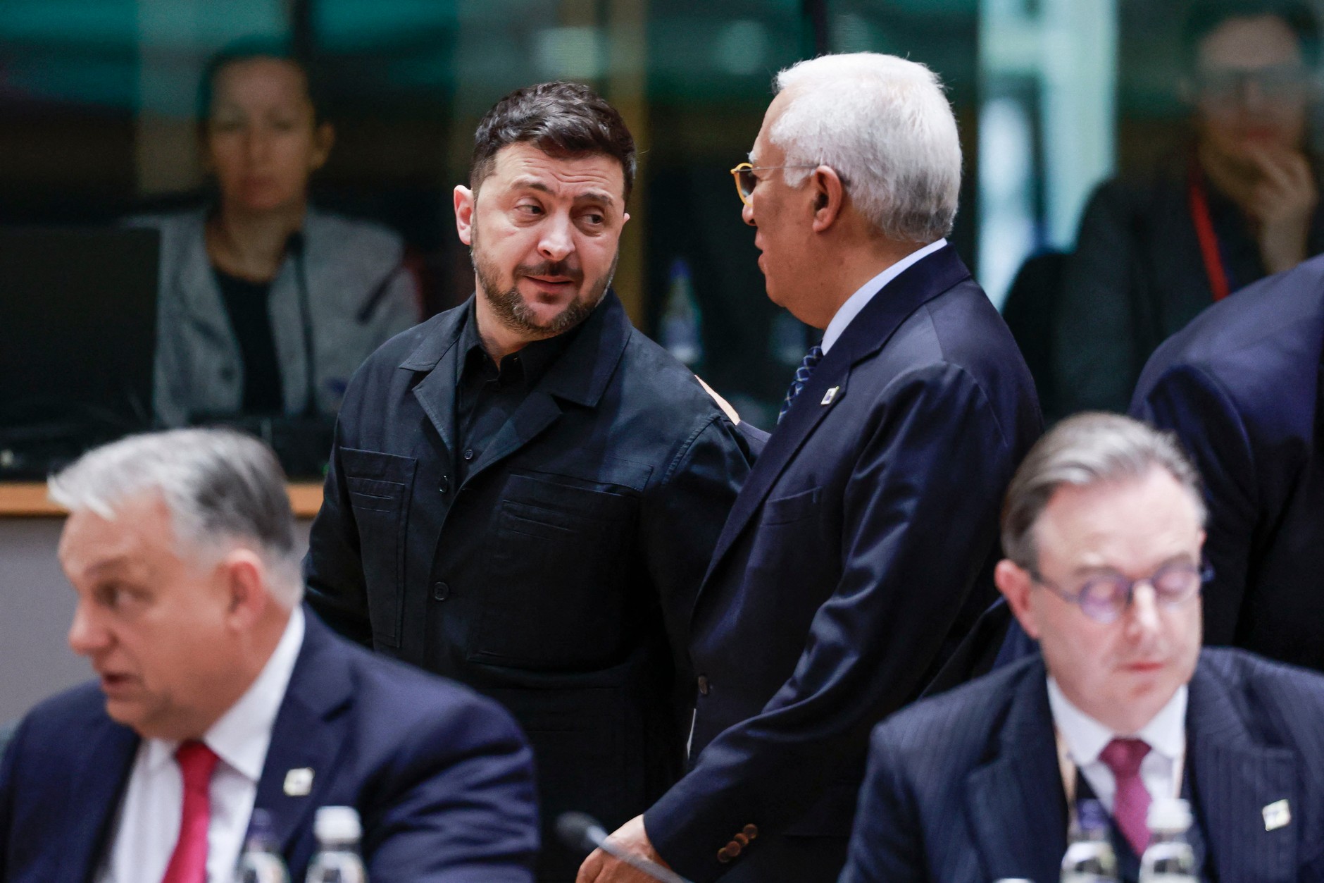 Ukrainian President Volodymyr Zelensky talks with European Council President Antonio Costa during the EU summit in Brussels, December 18, 2025.