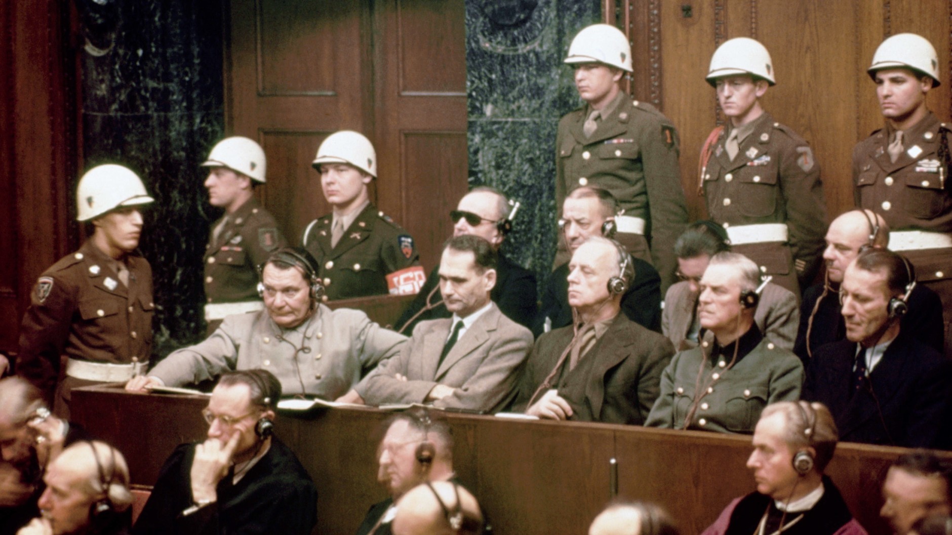 Proces w Norymberdze. Na ławie oskarżonych siedzą: Hermann Göring, Rudolf Hess, Joachim von Ribbentrop, Wilhelm Keitel i Ernst Kaltenbrunner. W tylnym rzędzie: Karl Dönitz, Erich Raeder, Baldur von Schirach i Fritz Sauckel.