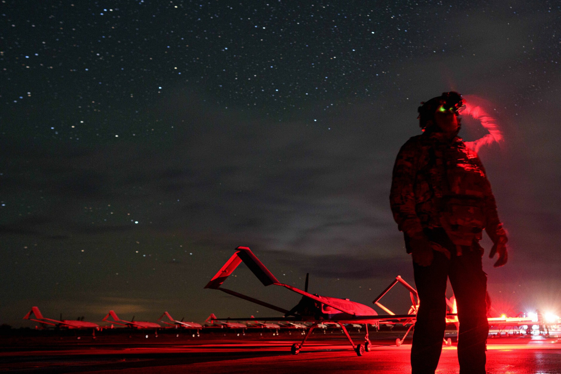 A Ukrainian commander looks through night vision goggles before launching long-range Lutyj drones toward Russia at an undisclosed location in Ukraine, October 14, 2025.