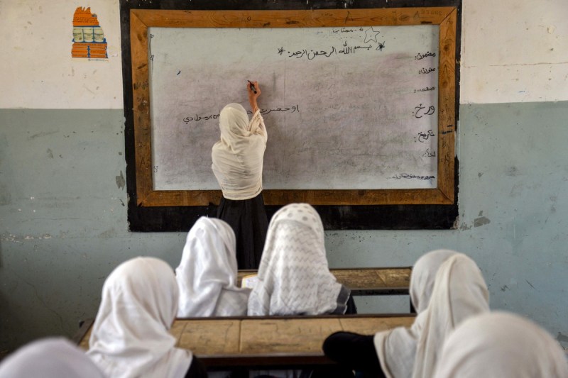The image of an Afghan girl studying, named the Photo of the Year 2025 by UNICEF