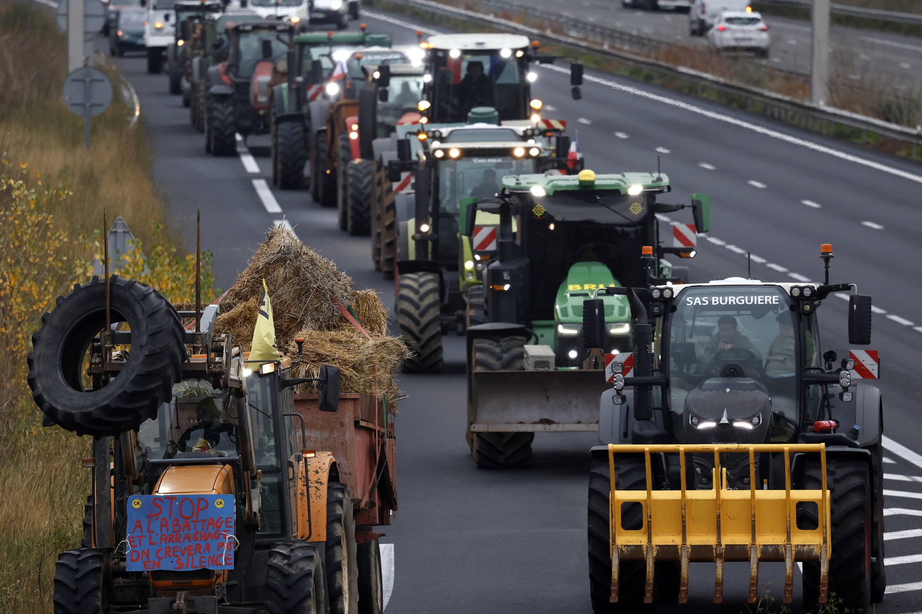 Banner with the inscription "Stop the slaughter, we will die in silence" placed on a tractor during a farmers' protest on the A9 motorway in Beziers, France, December 16, 2025. 