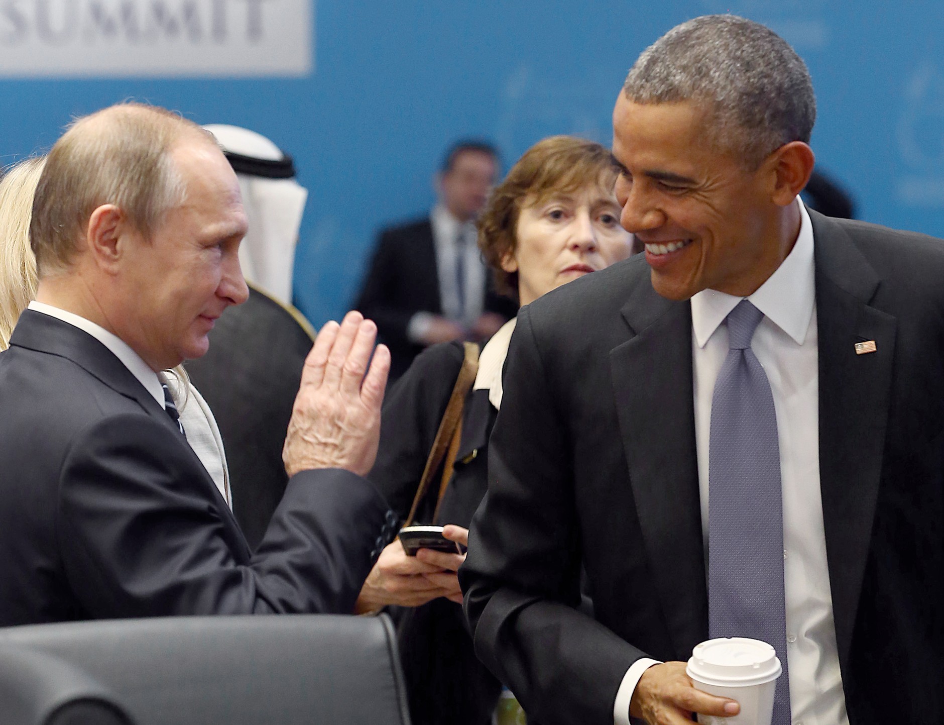 Russian President Vladimir Putin and then-U.S. President Barack Obama talk before the second working session during the G20 summit in the Turkish Mediterranean resort of Antalya, November 16, 2015.