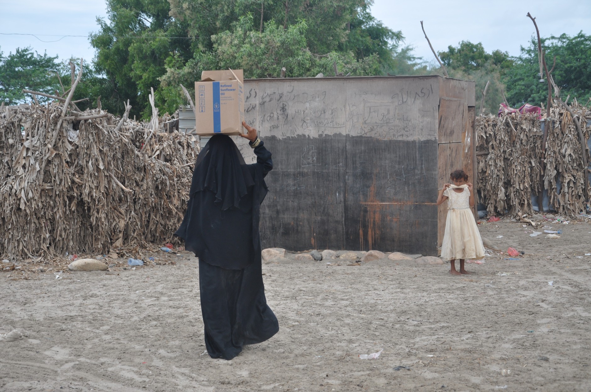 A woman from Yemen looking for food to feed her family