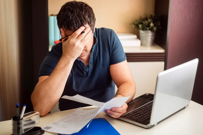 A man anxiously reads how much tax he has to pay on the 35 square meter house