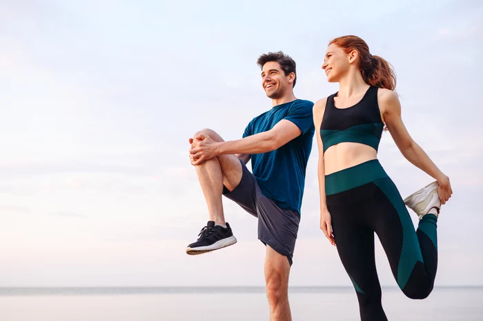 a man and a woman preparing to run