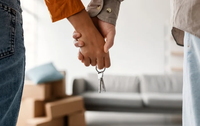 Two young people holding hands