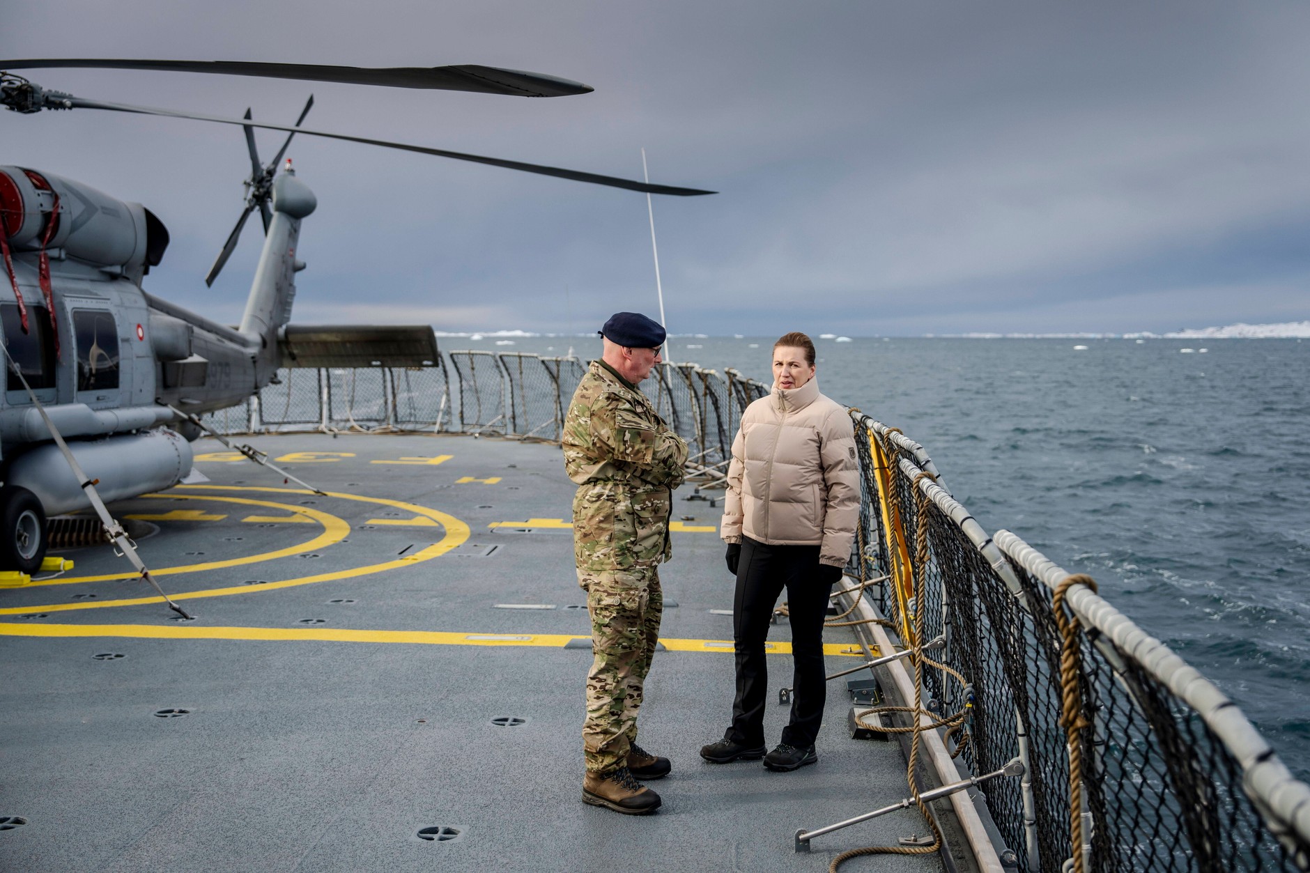 Commander of the Joint Arctic Command Major General Soren Andersen (L) and Danish Prime Minister Mette Frederiksen aboard the Danish inspection ship Vaedderen in waters near Nuuk, Denmark, April 3, 2025.