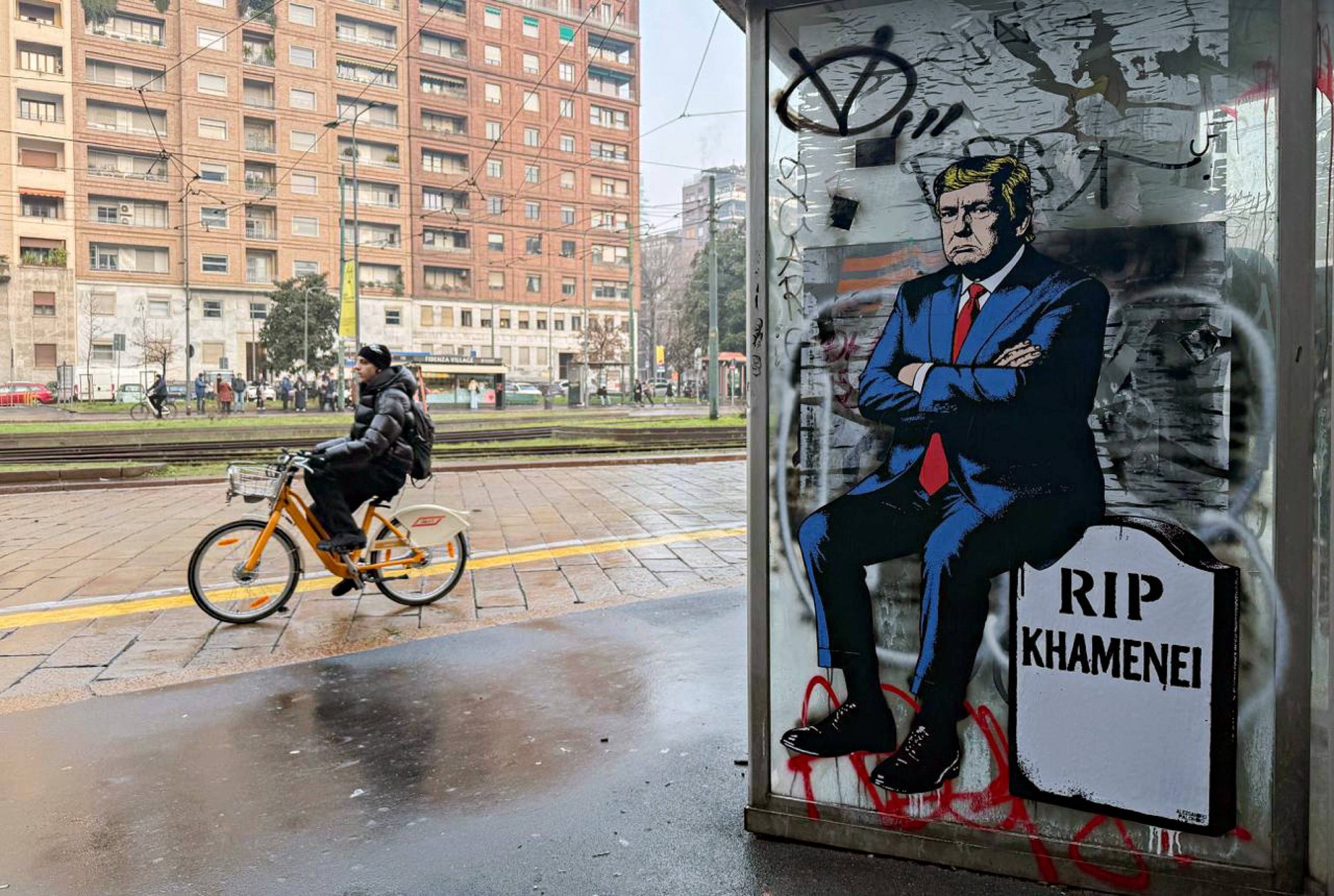 A mural by Italian artist aleXsandro Palombo depicting Donald Trump sitting on a tombstone with an inscription "RIP Khamenei". Milan, January 16, 2026