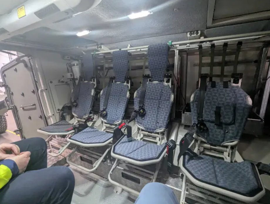 The interior of the Patria 6x6 features a relatively simple design, with metal seats and storage compartments for firearms and equipment