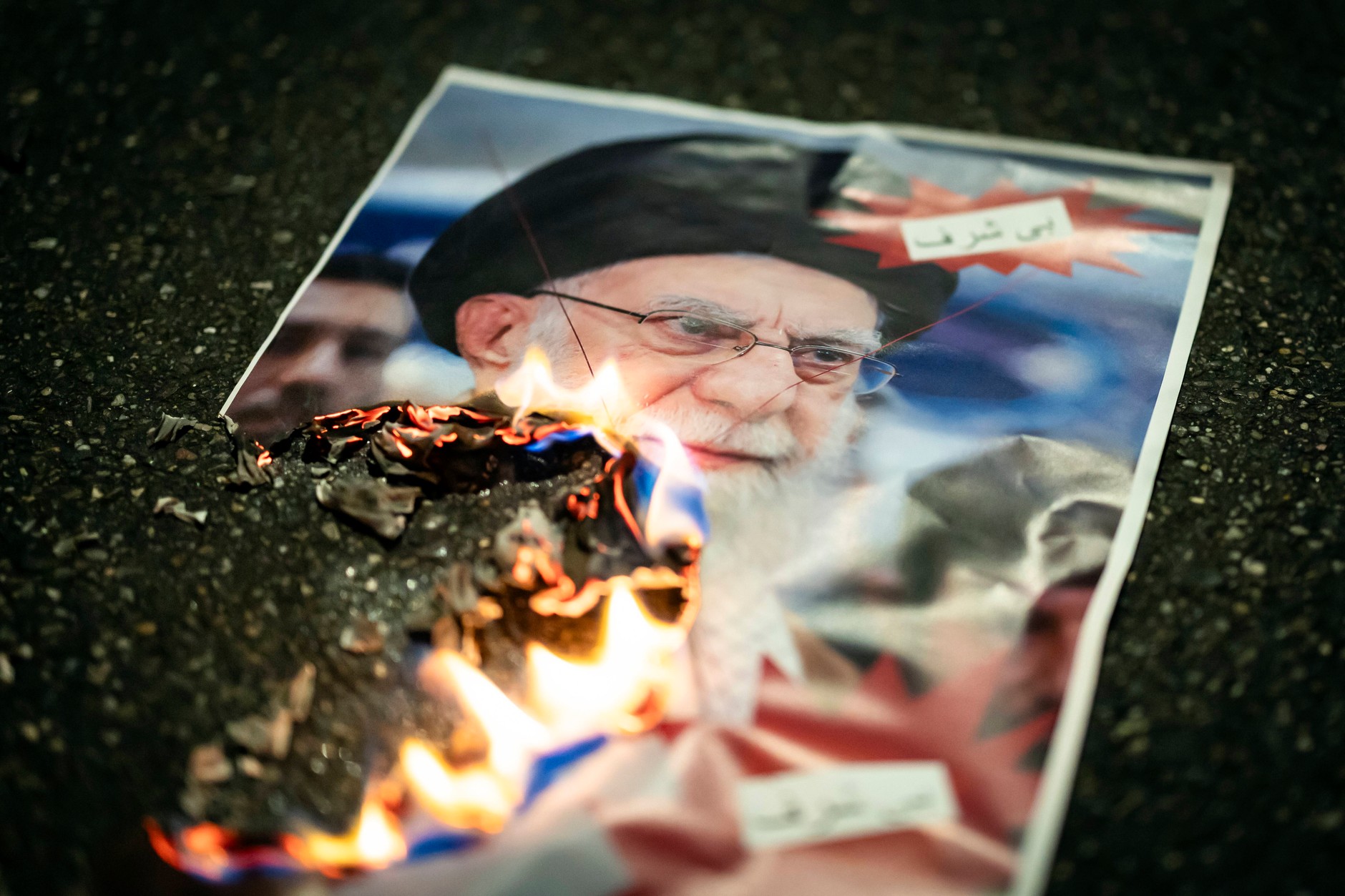 A photo of Iranian leader Ali Khamenei is burned during a rally in support of nationwide mass demonstrations against the government in Iran. Zurich, Switzerland, January 13, 2026