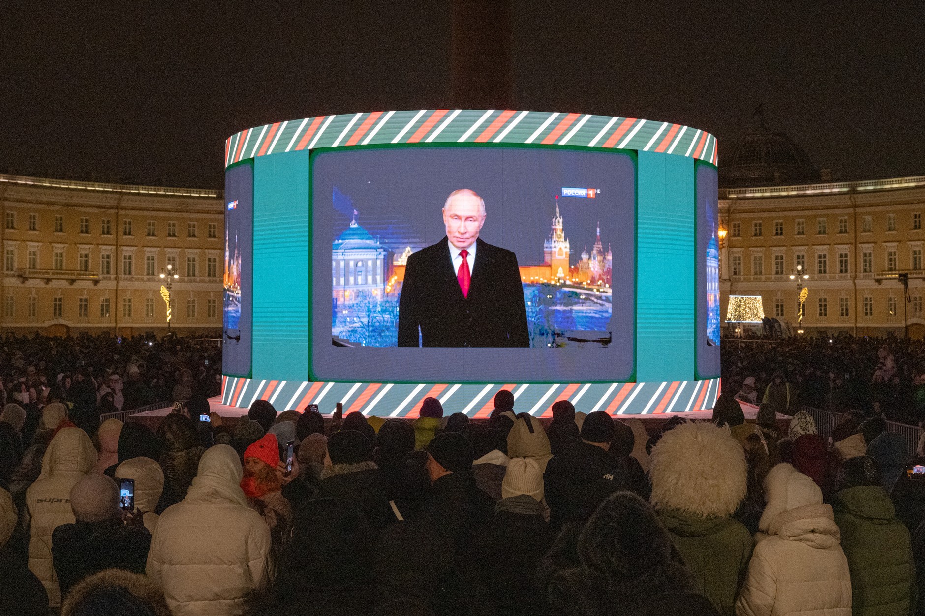 Residents watch a broadcast of Russian President Vladimir Putin's speech in Saint Petersburg, December 31, 2025. 