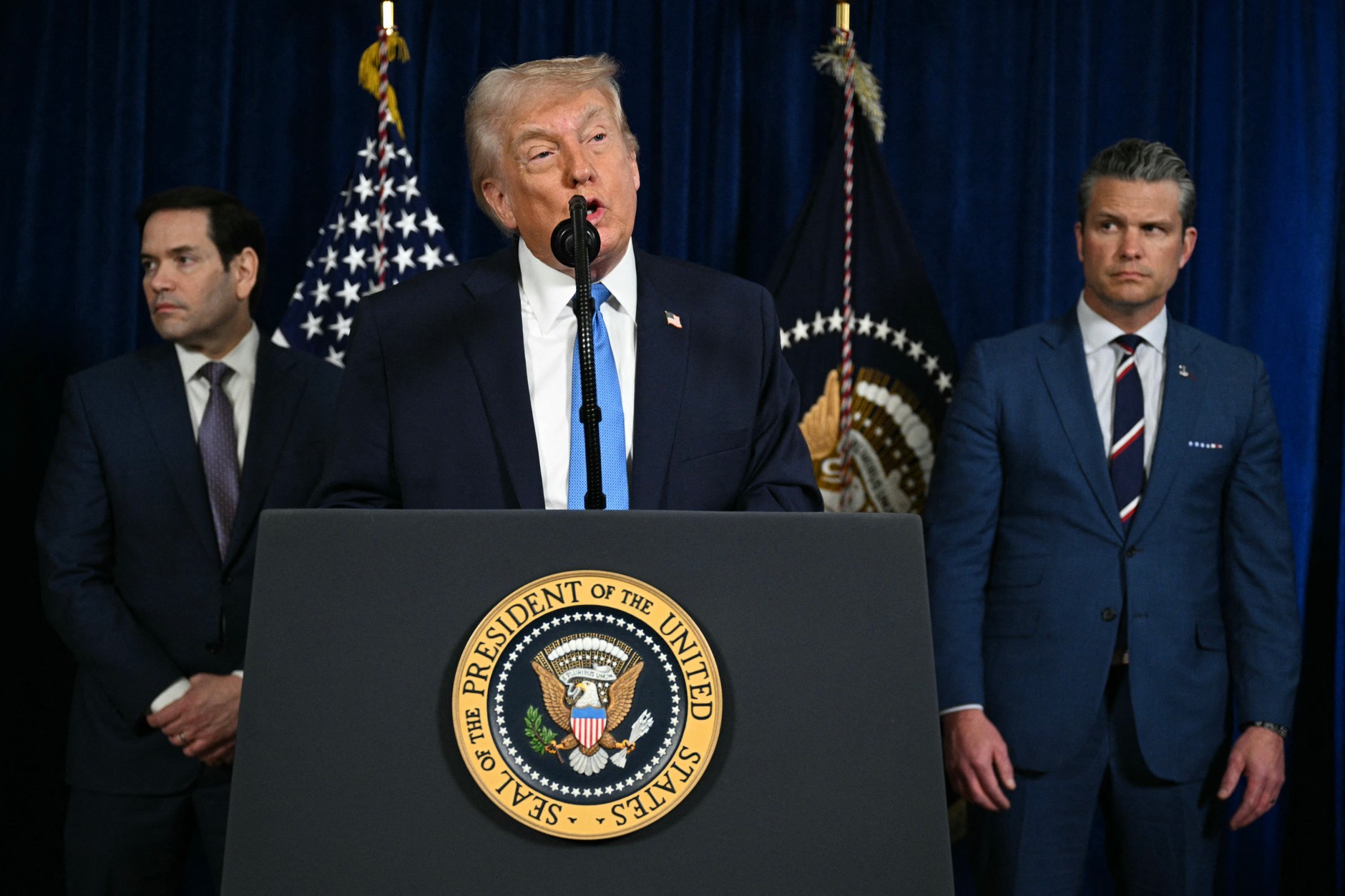US President Donald Trump with Secretary of State Marco Rubio (left) and US Secretary of Defense Pete Hegseth (right) during a conference at Mar-a-Lago in Palm Beach, Florida, January 3, 2026.