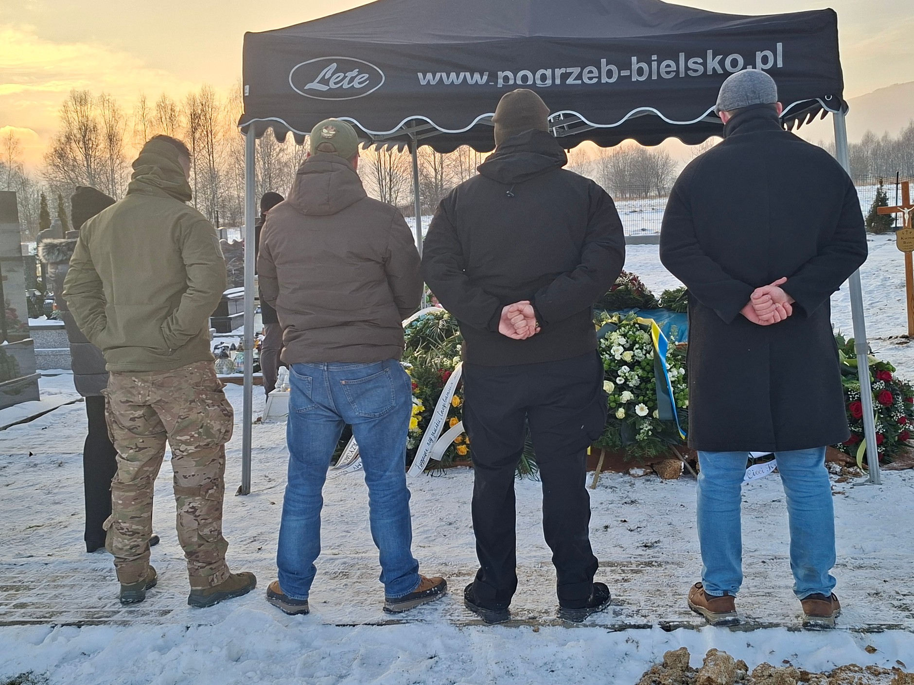 Polish volunteers at the grave of Kacper Bass.