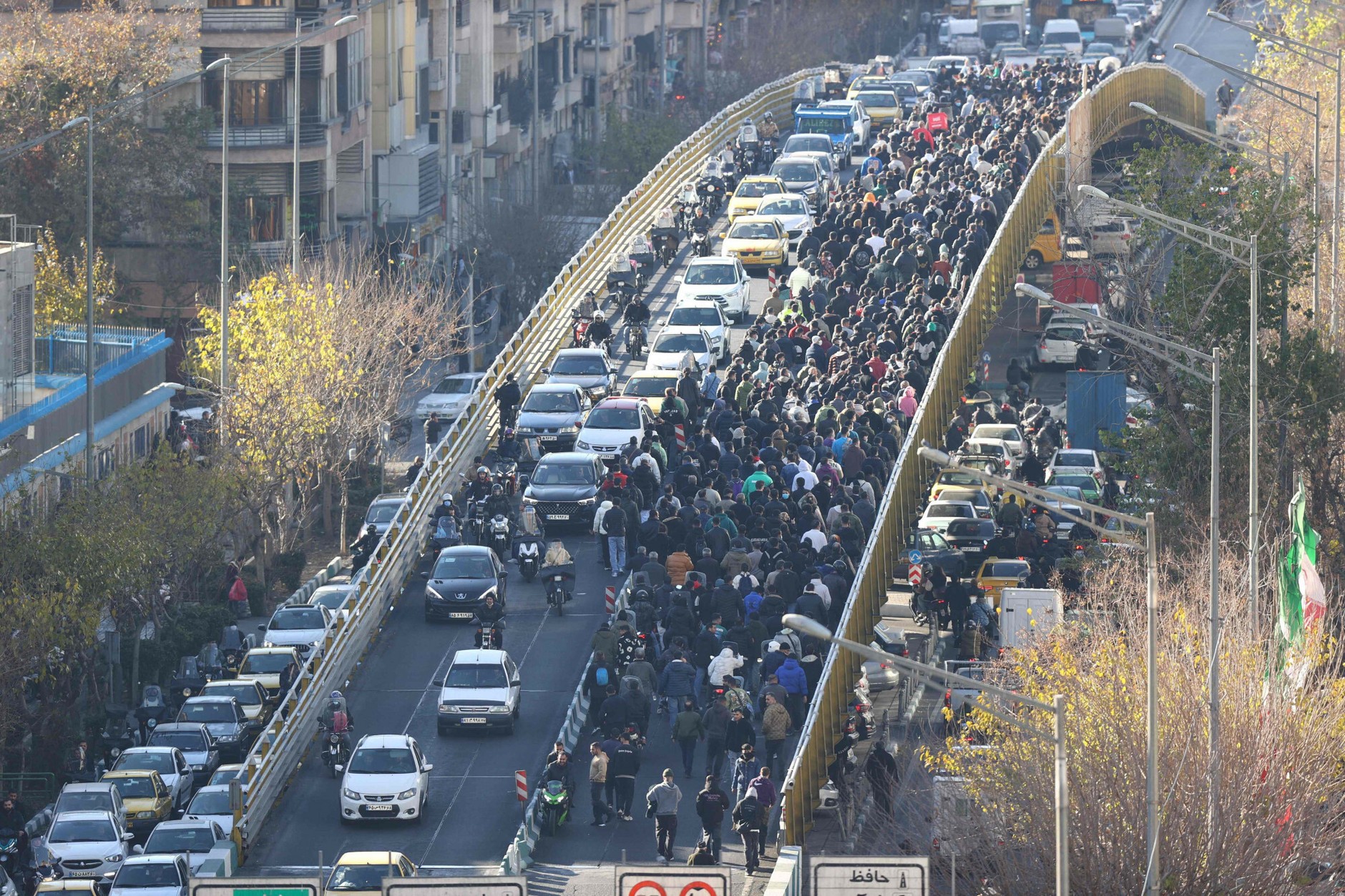 Shop owners and traders cross a bridge during a protest against economic conditions and the weakening of Iran's currency, Tehran, December 29, 2025.