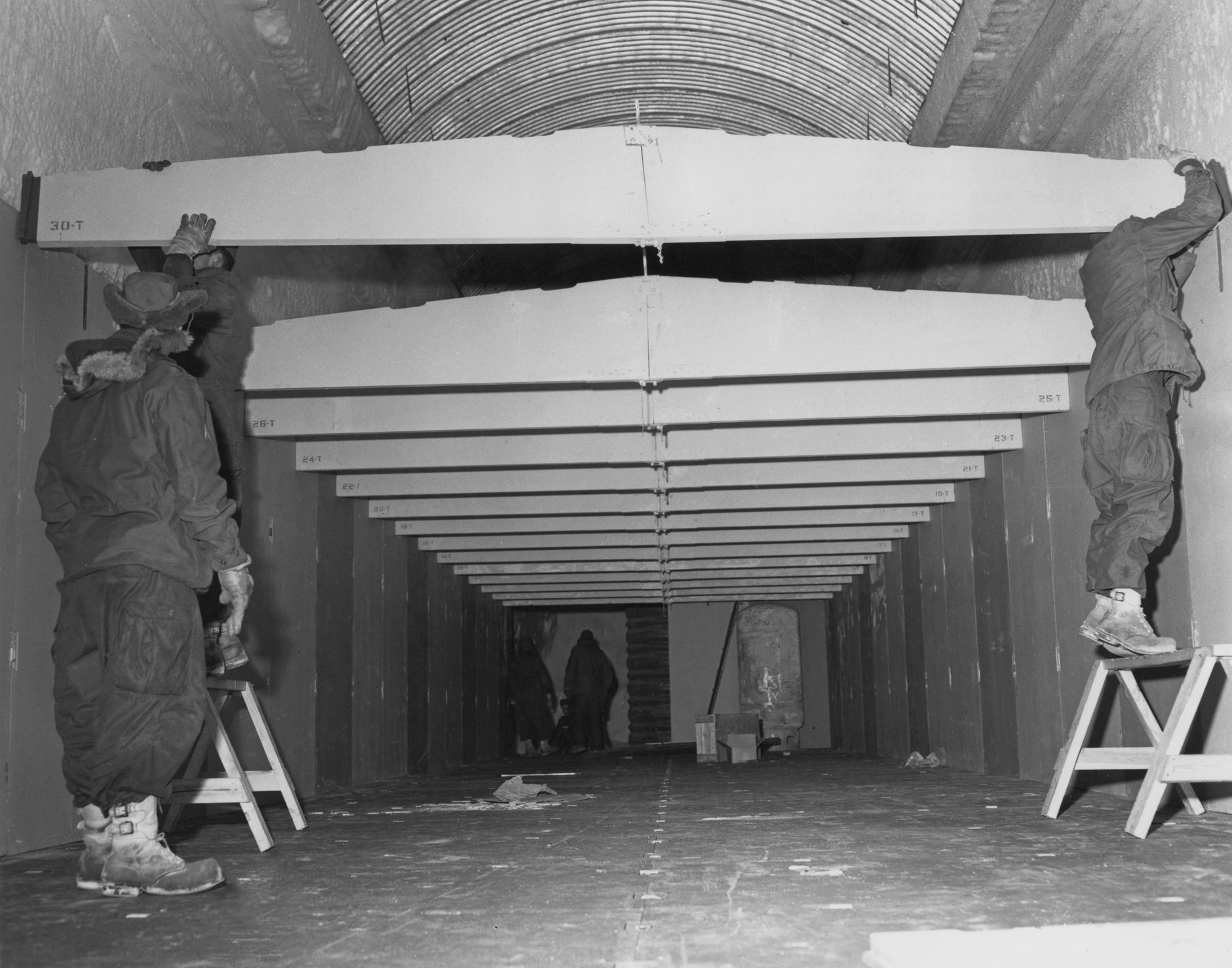 Men from the U.S. Army Polar Research and Development Center constructing a building "T5" in a side trench at Camp Century, a U.S. Arctic military research base in Greenland, June 1959.