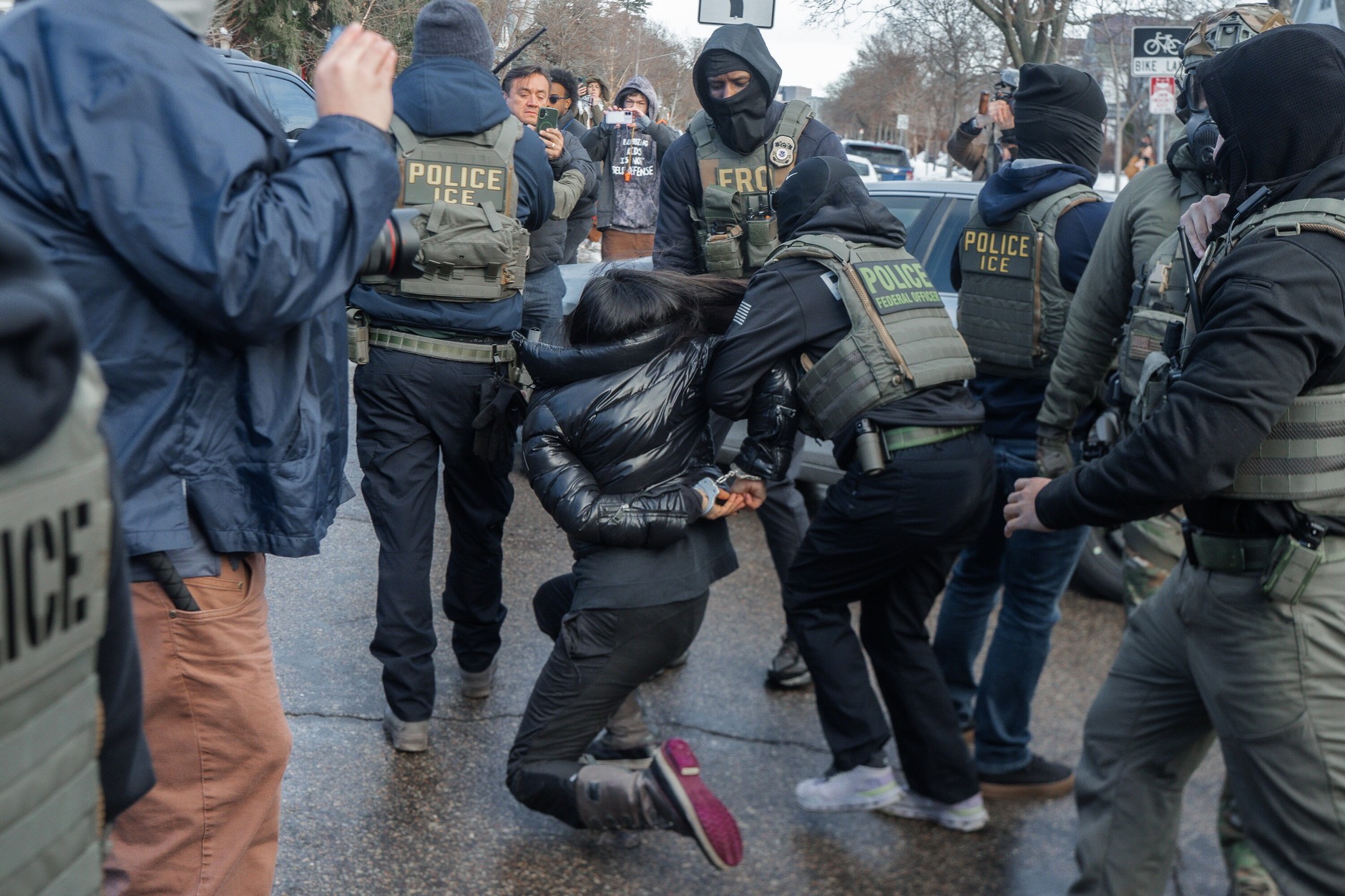 A woman is detained by immigration officers. Minneapolis, January 13, 2026