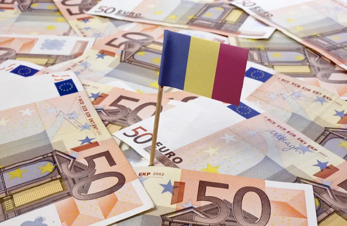 50 euro banknotes on a table, on which the Romanian flag is embedded