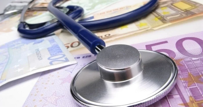 A stethoscope placed on 20 and 50 euro banknotes