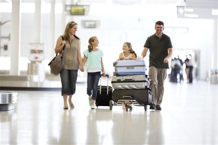 Family with two children and a lot of luggage in an airport