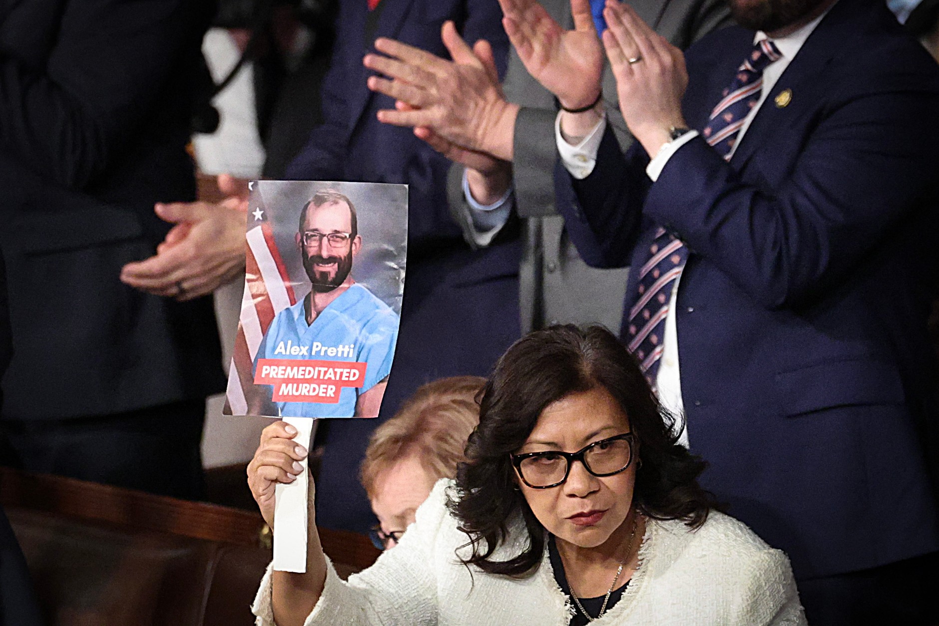 Democrat Norma Torres holds a photo of Alex Pretti during Trump's speech, February 24, 2026.