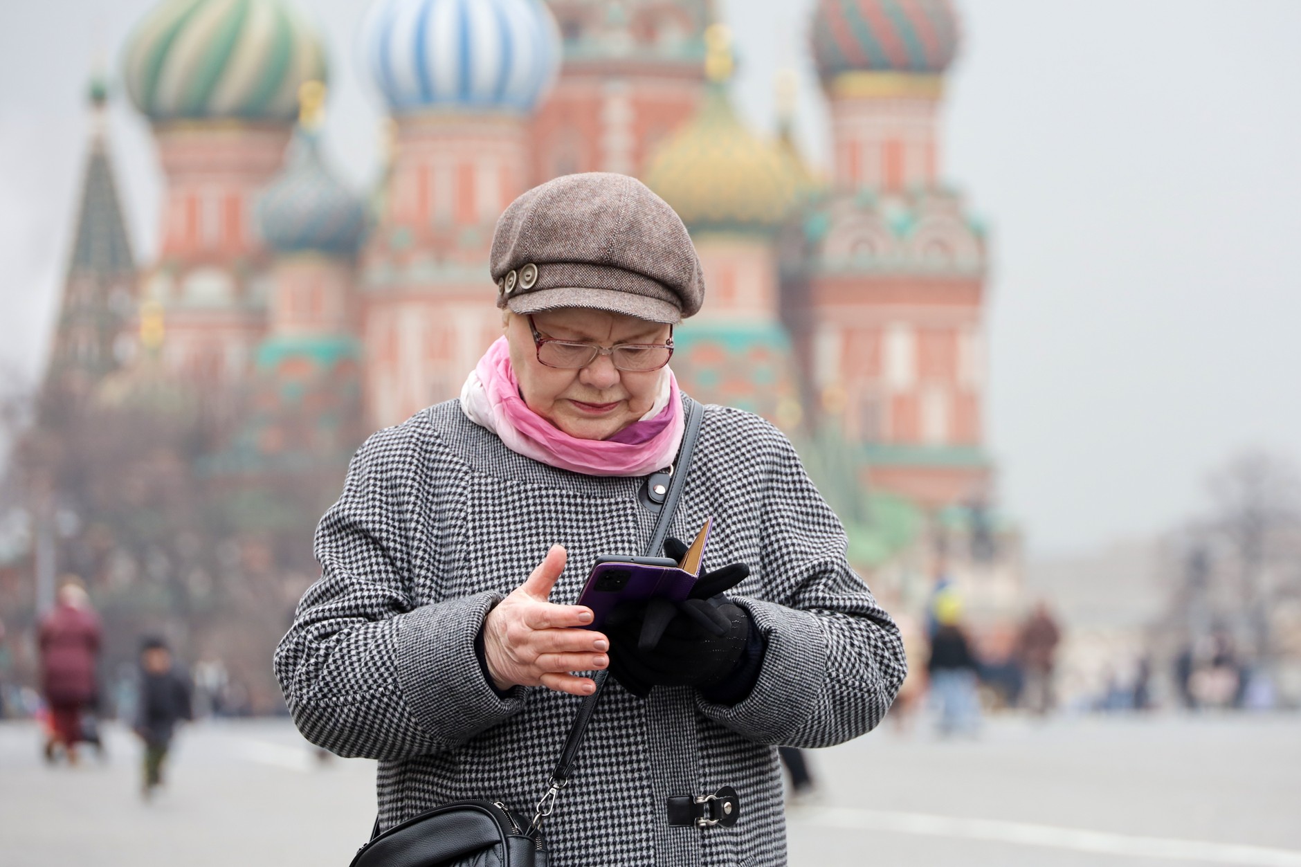 Woman with smartphone on Red Square in Moscow. Illustrative photo