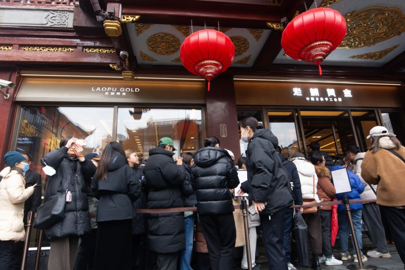 Chinese people line up to sell their family jewels. They have machines that give money for gold