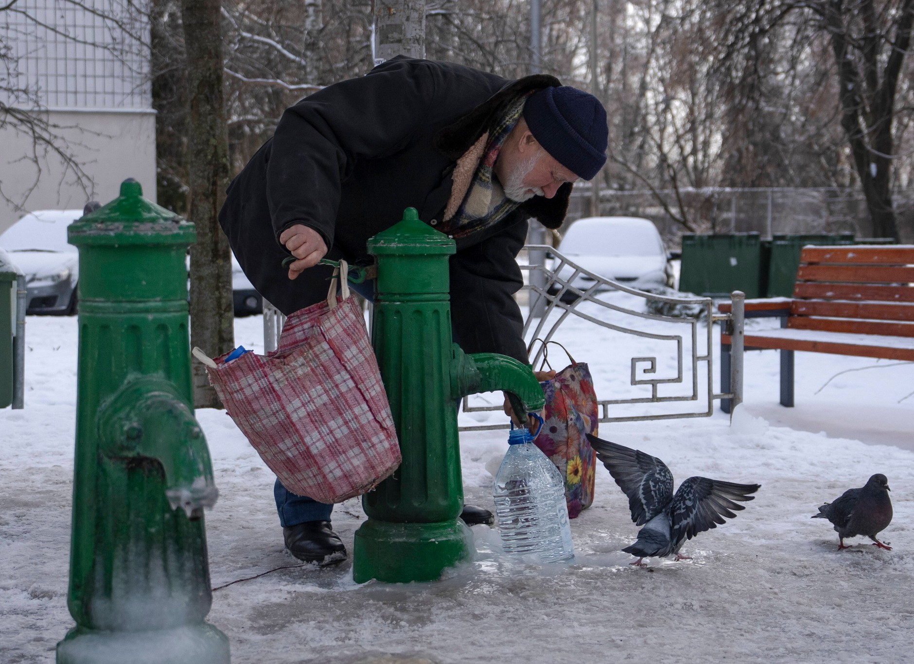 A resident draws water from a public pump in Kiev, Ukraine, January 24, 2026.