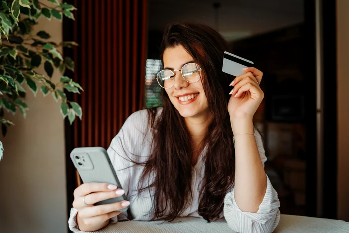 young woman with credit card in hand