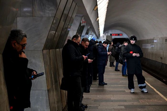 Russians using their phones while waiting for the subway PHOTO AFP