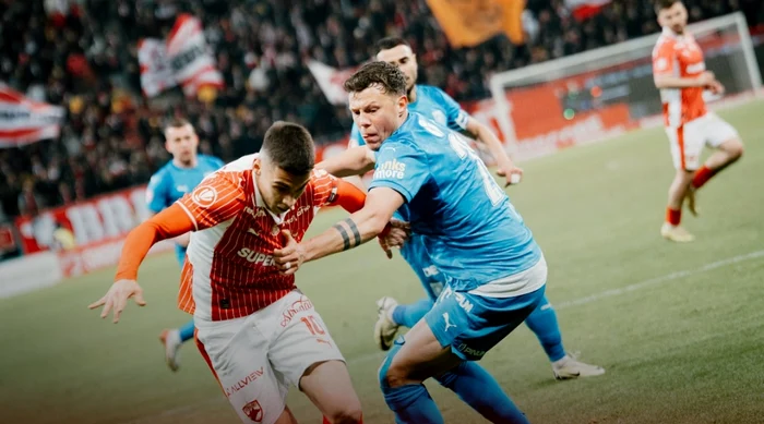 Cătălin Cârjan, held in check by Adrian Rus. Dynamo Facebook photo