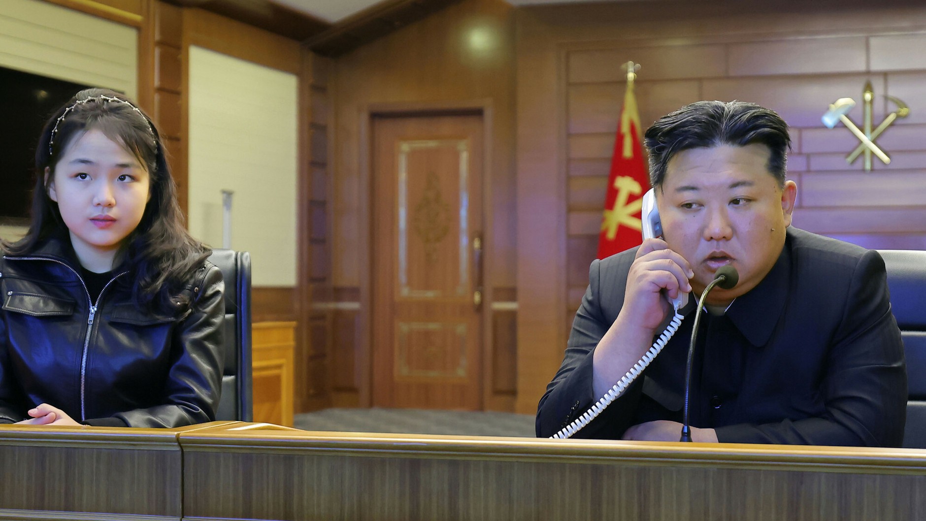 Kim Ju Ae and Kim Jong Un watch a broadcast of a cruise missile launch on March 10, 2026.