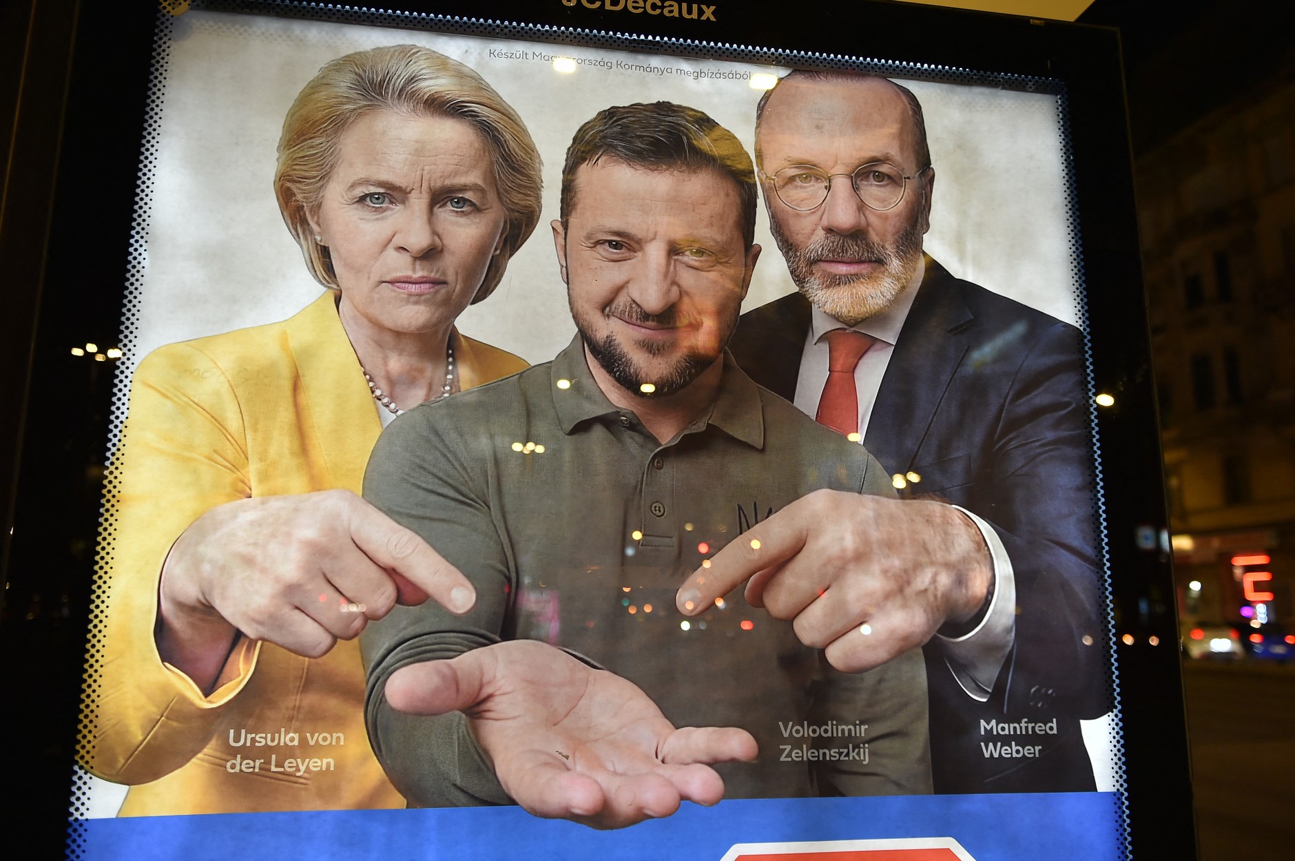 Images of Ursula von der Leyen, Volodymyr Zelensky and Manfred Weber on a billboard in Budapest