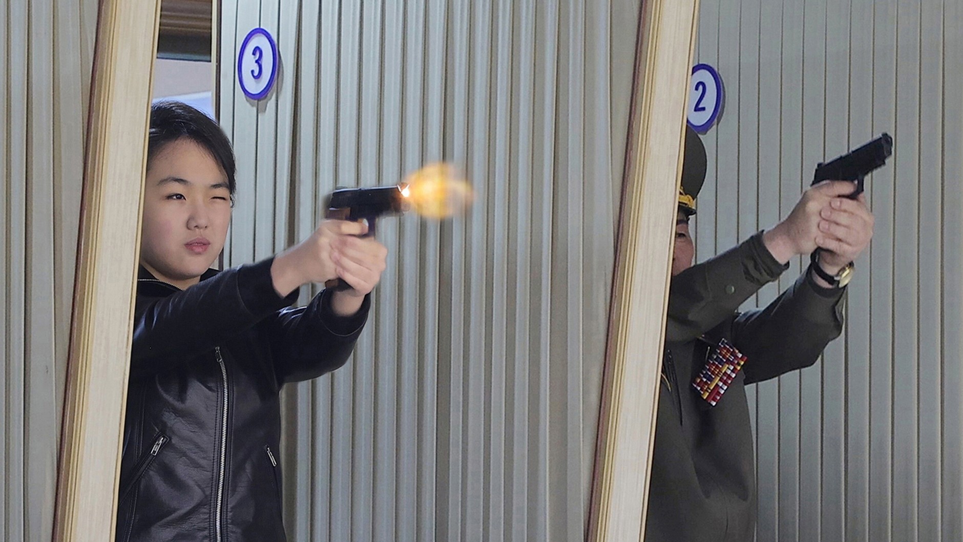 Kim Ju Ae tests a pistol at a North Korean weapons factory, March 11, 2026.