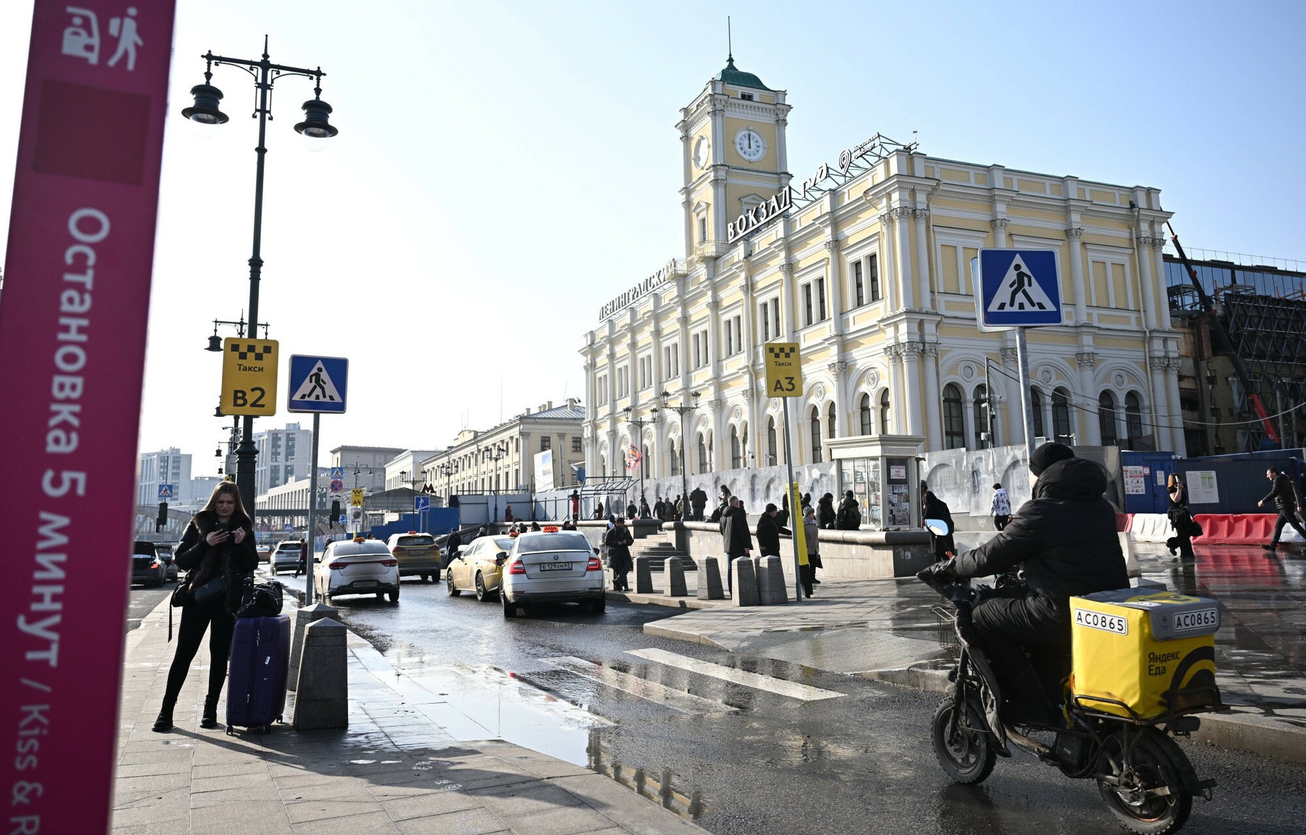 A woman waits at a taxi rank near the train station in Moscow, Russia, March 12, 2026.