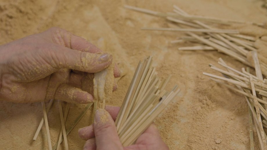 Making aburi-mochi starts with wooden skewers