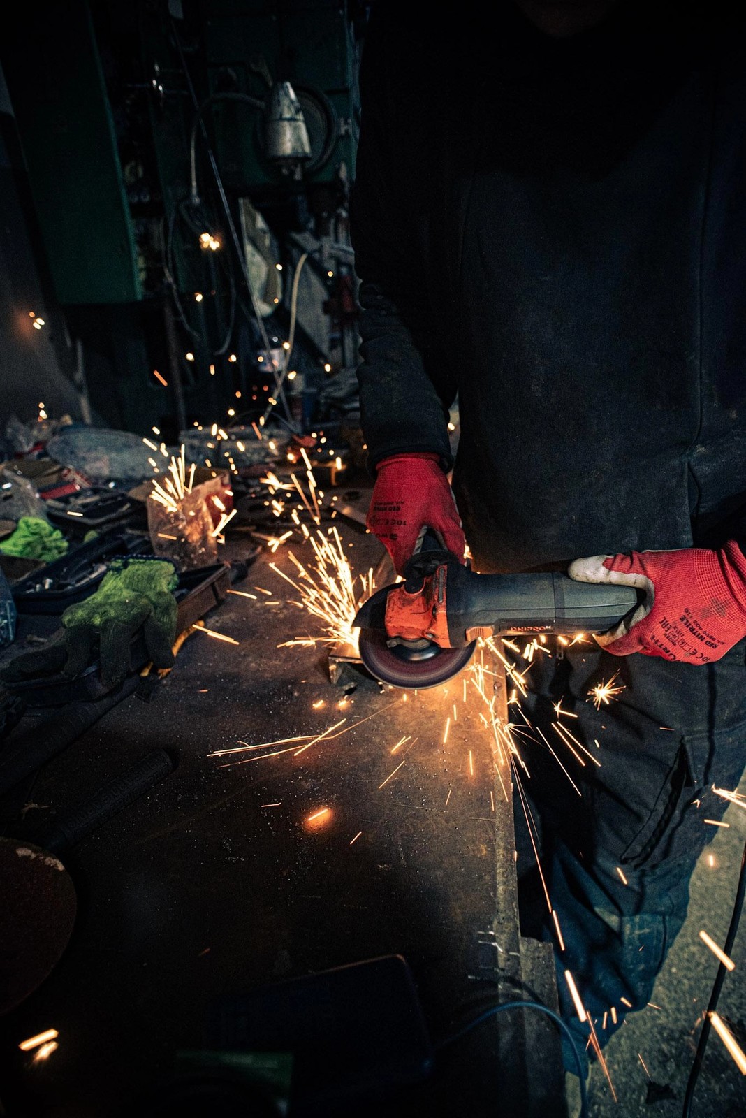 A soldier of the Chartia Brigade cuts and welds elements for unmanned land vehicles