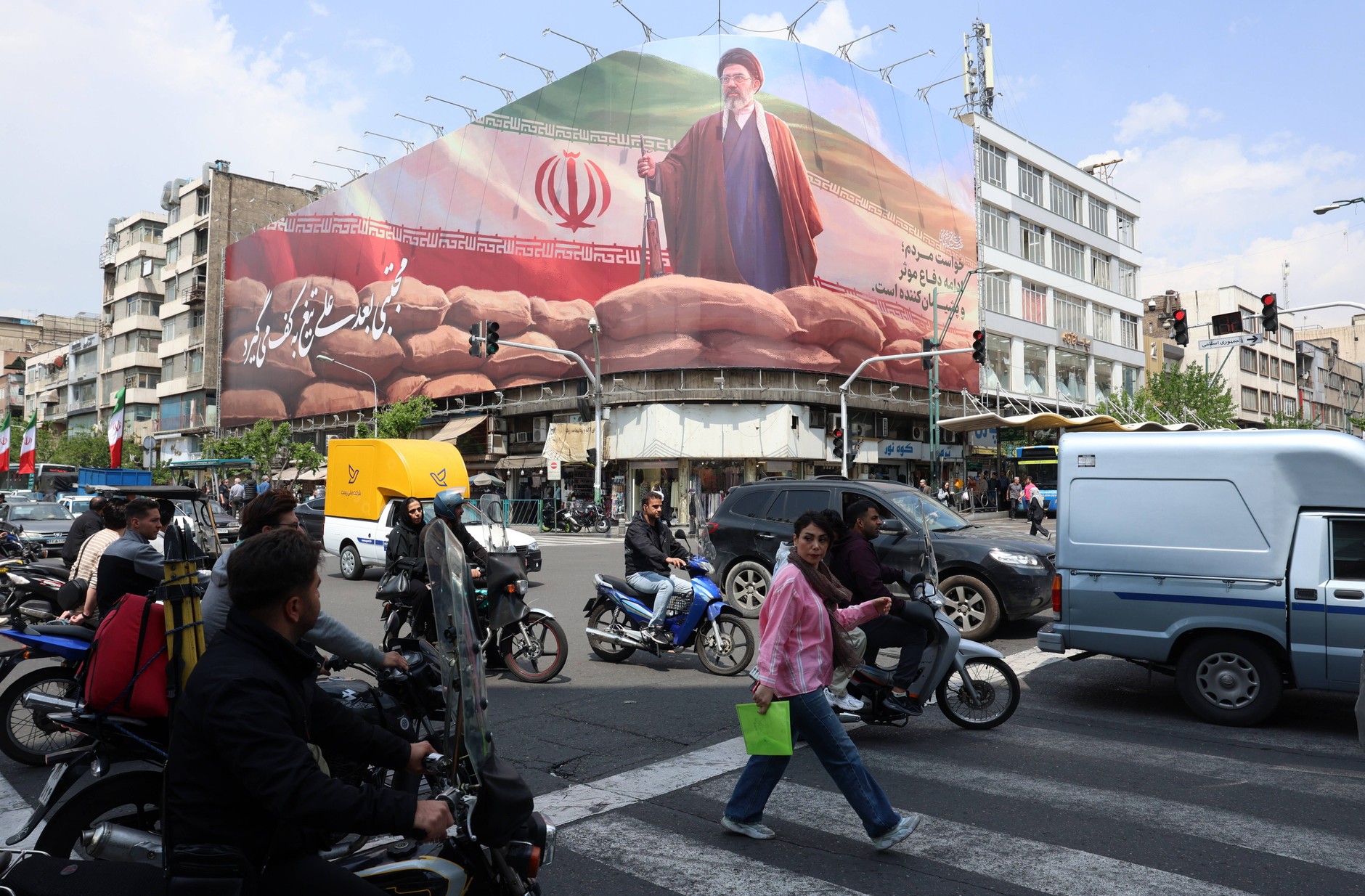 Iranians drive past a large billboard with the image of Iran's Supreme Leader Ayatollah Mojtaba Khamenei on a street in Tehran (April 20, 2026)