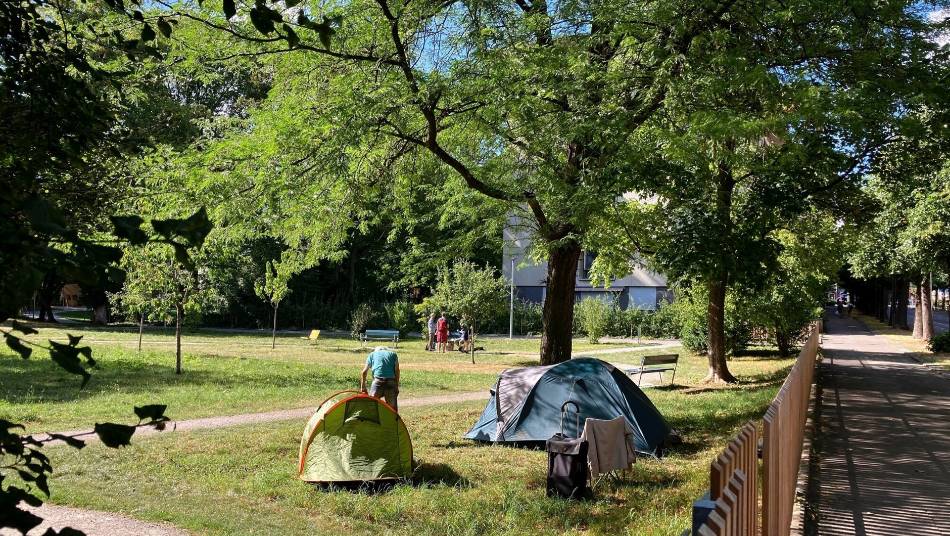 People in crisis of homelessness sleeping in a park in the Swiss capital Bern